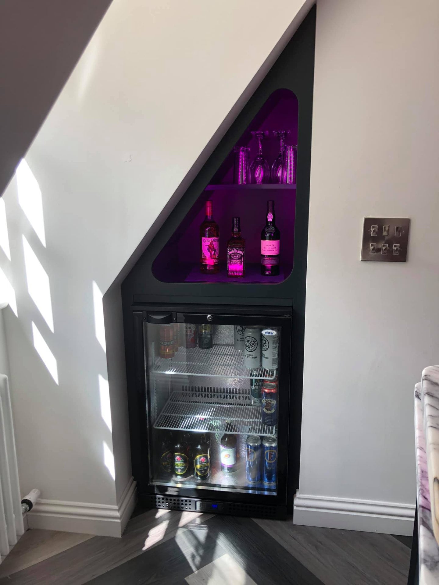 An integrated drinks cabinet with integrated lighting.