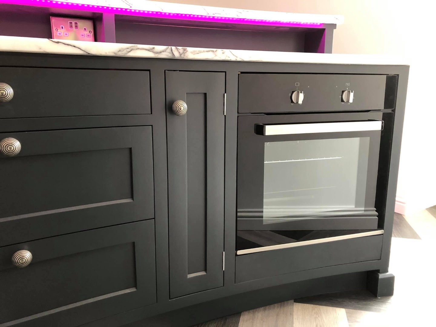 Beautiful storage cabinets and oven, fitted in a drinks bar.