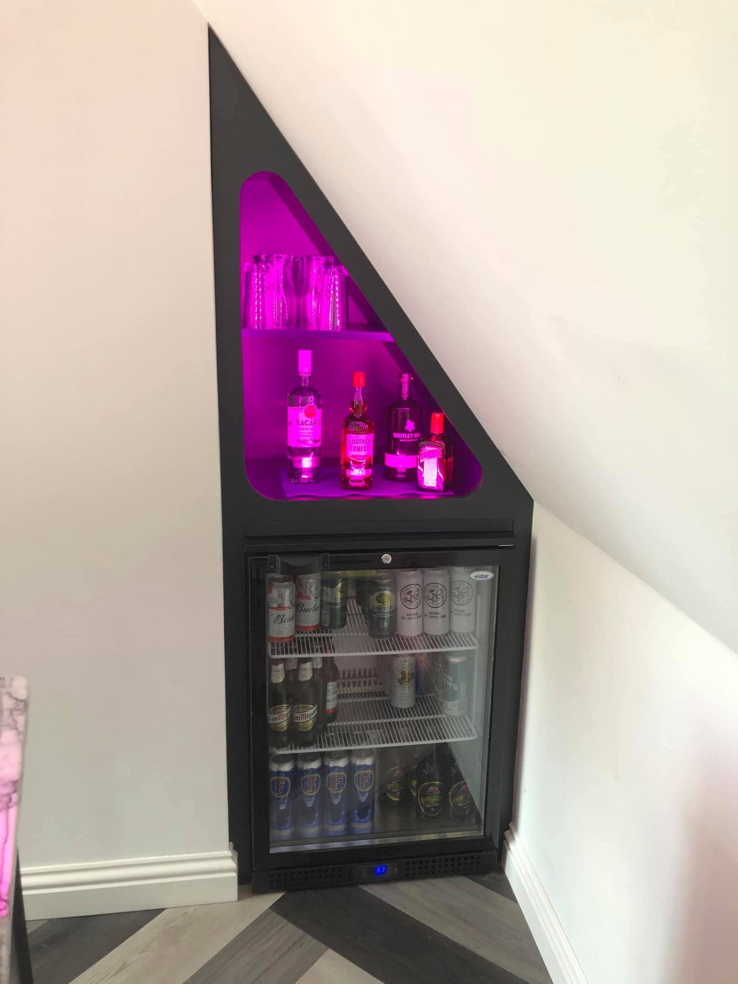 An integrated drinks cabinet with integrated lighting.
