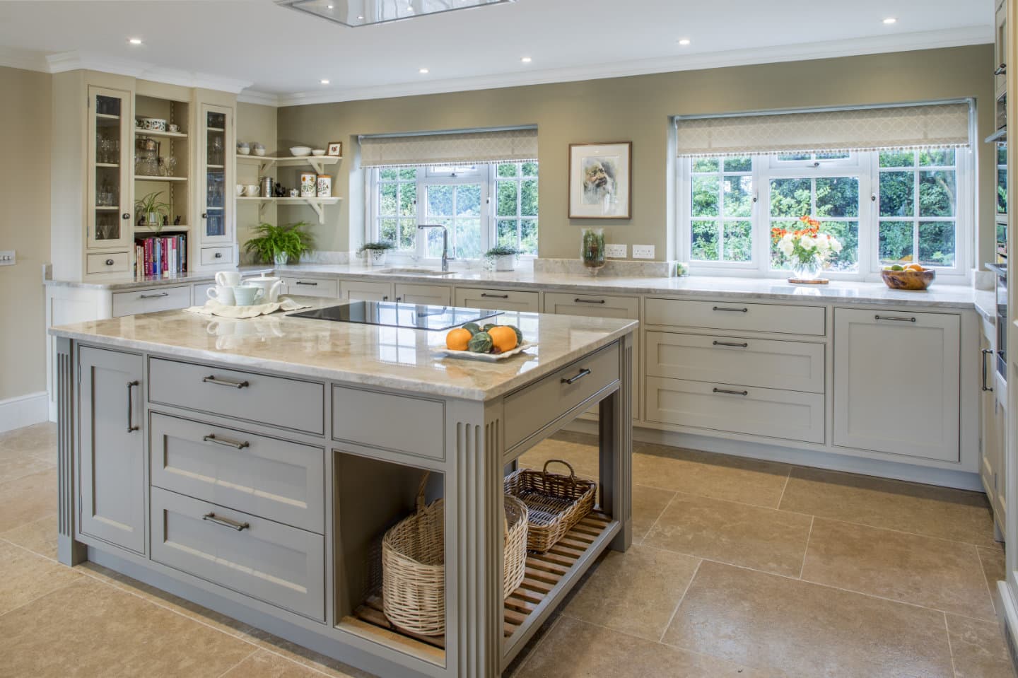 A kitchen island in the centre of a bespoke fitted kitchen.
