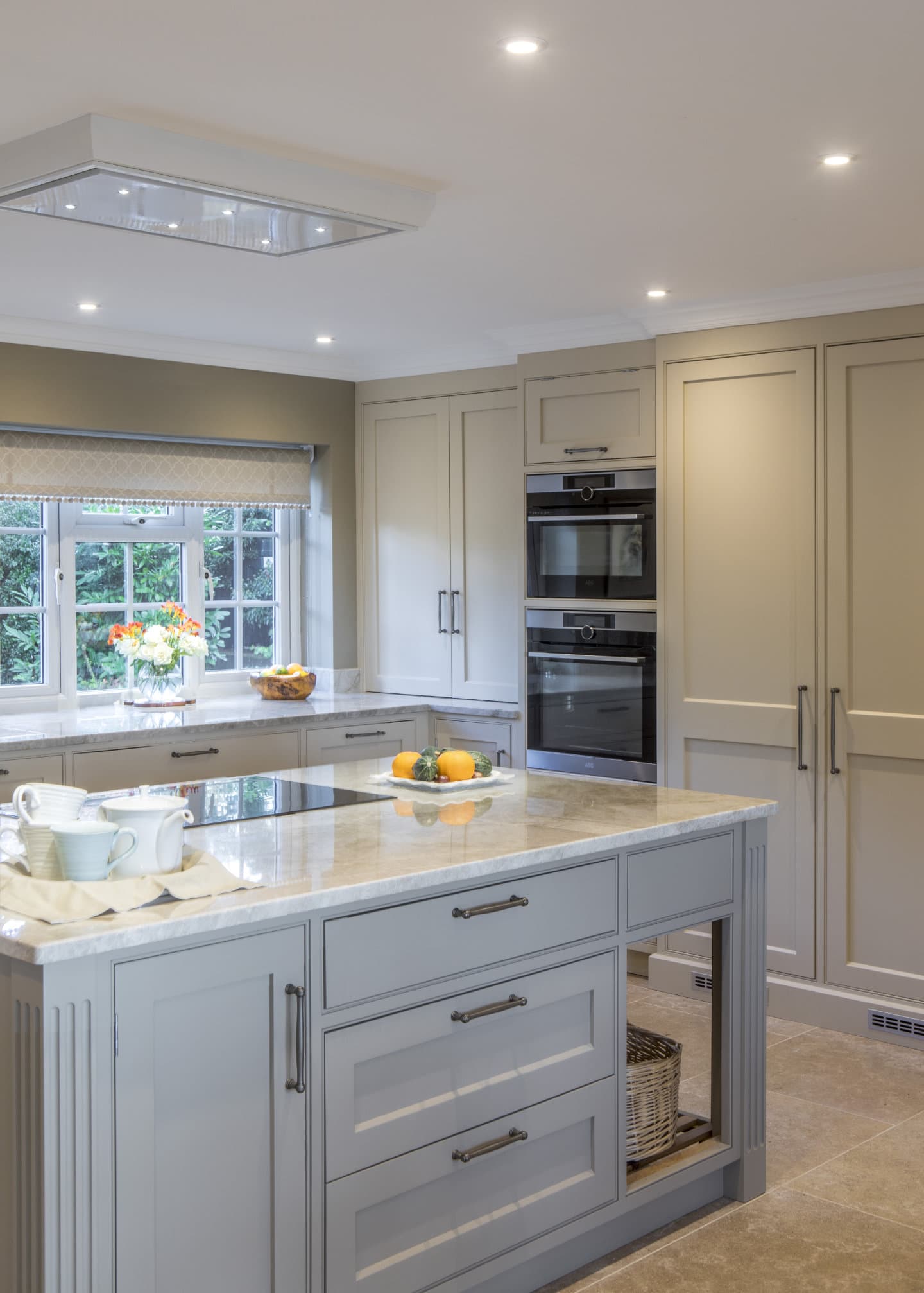 A view across a bespoke kitchen showing beautiful counter tops and fitted cupboards.
