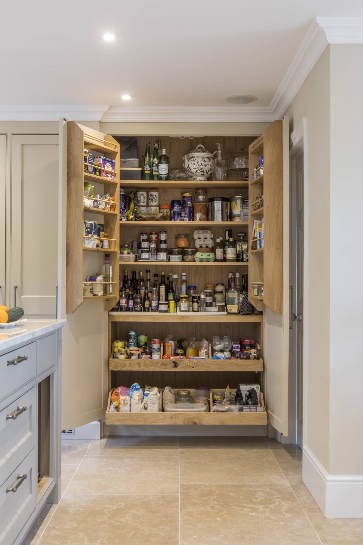 An open pantry showing shelves stacked with food.