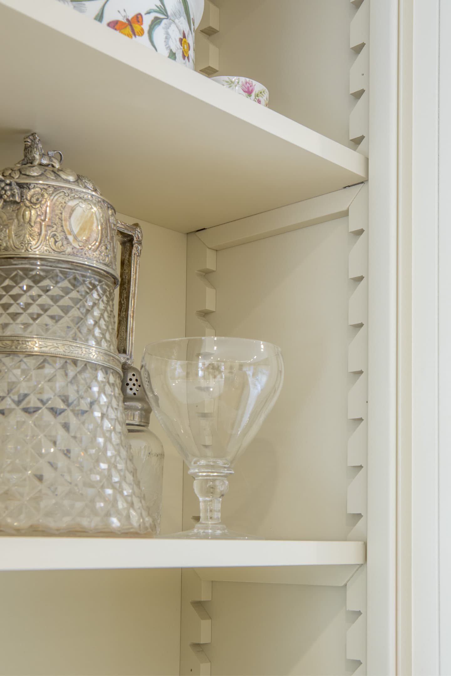 Some glassware sat in an open cupboard