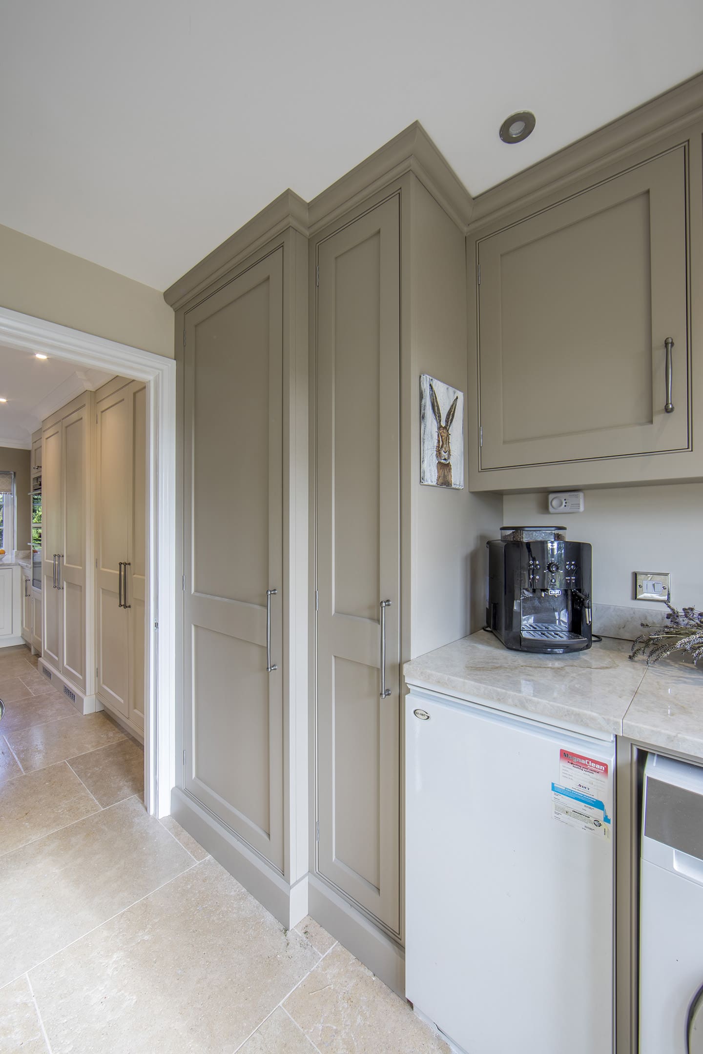 A wide view of a bespoke fitted utility room