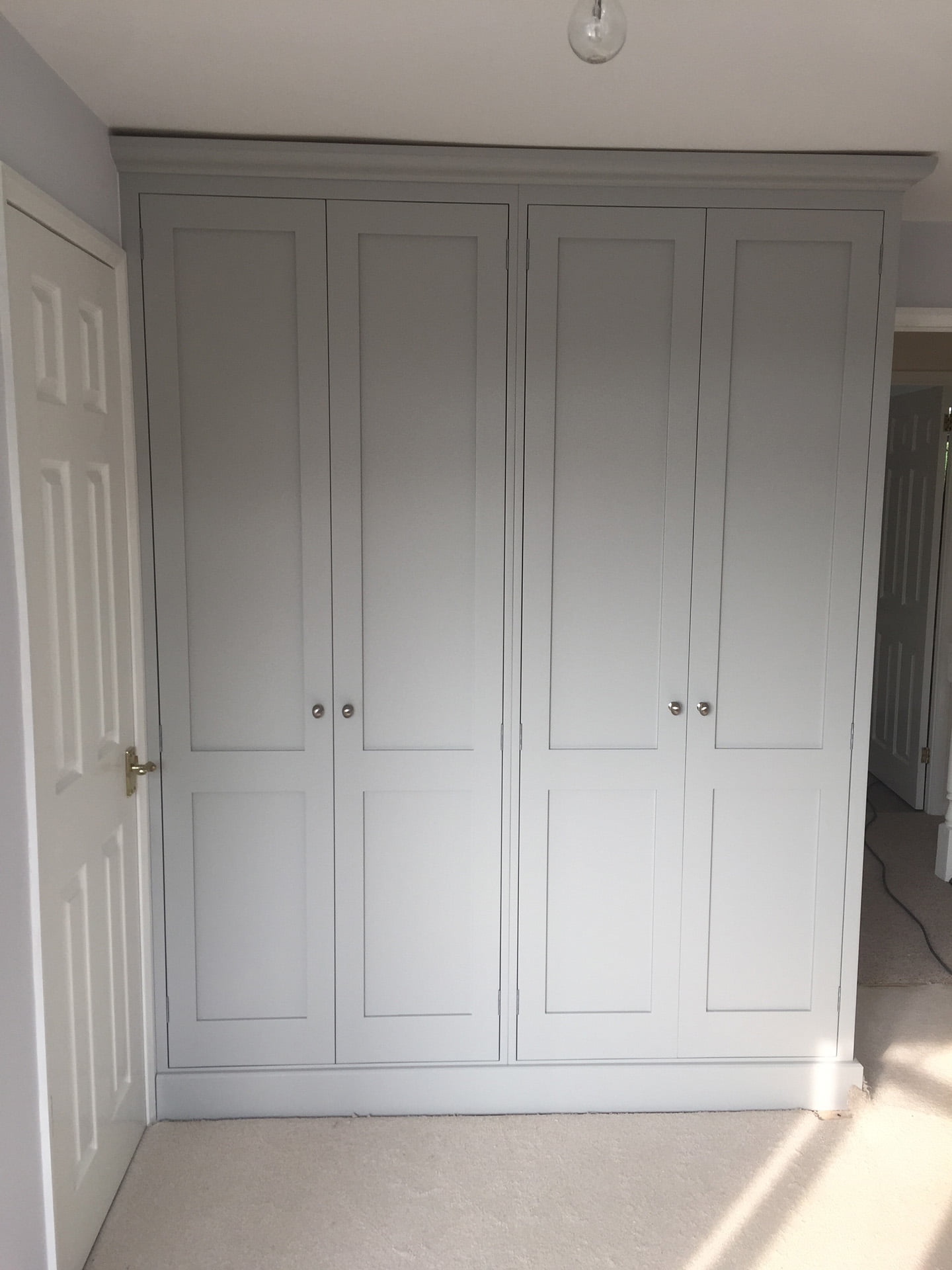 A front view of some bespoke wardrobes
