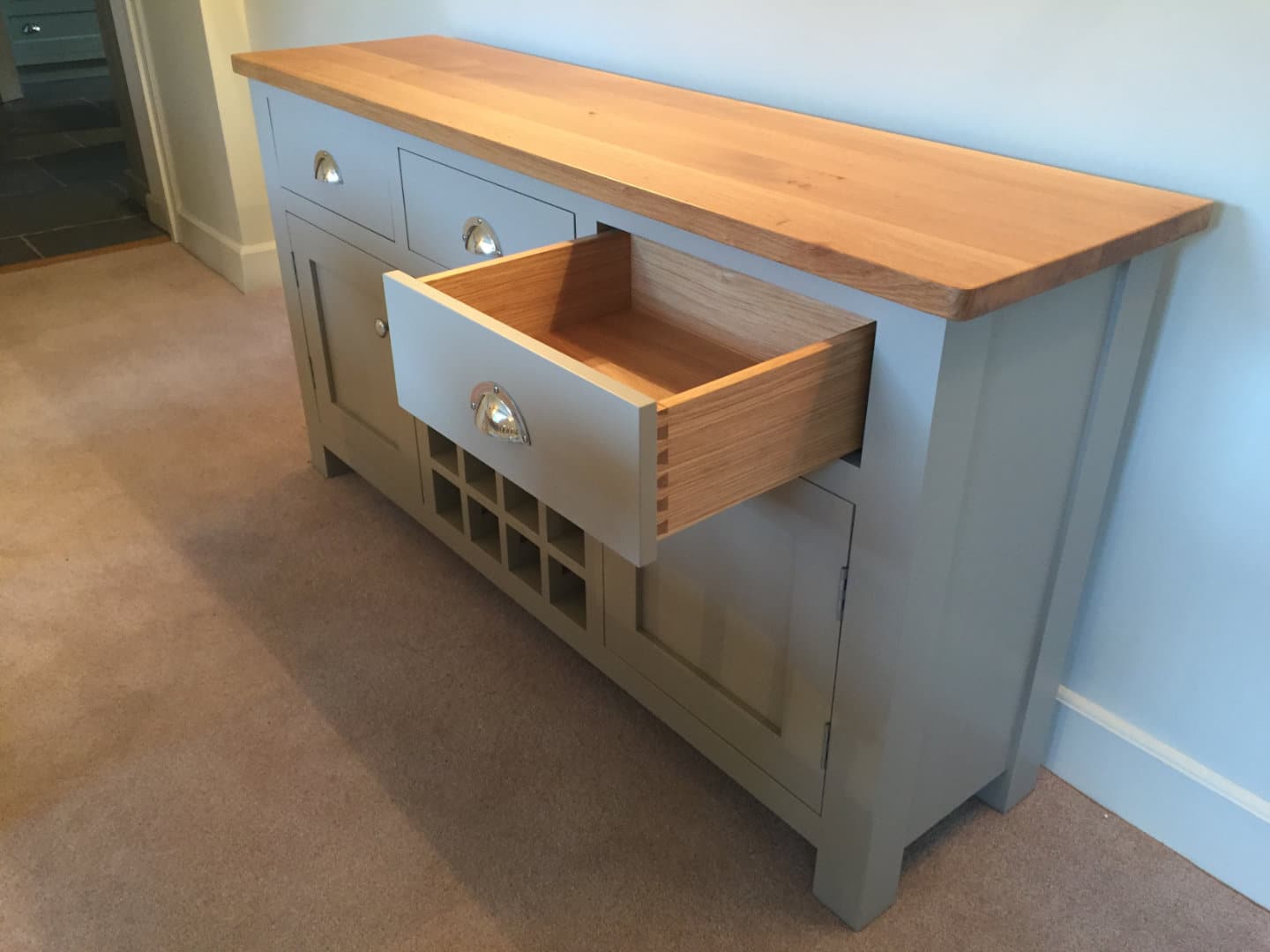 A beautiful wooden sideboard with on of it's drawers open
