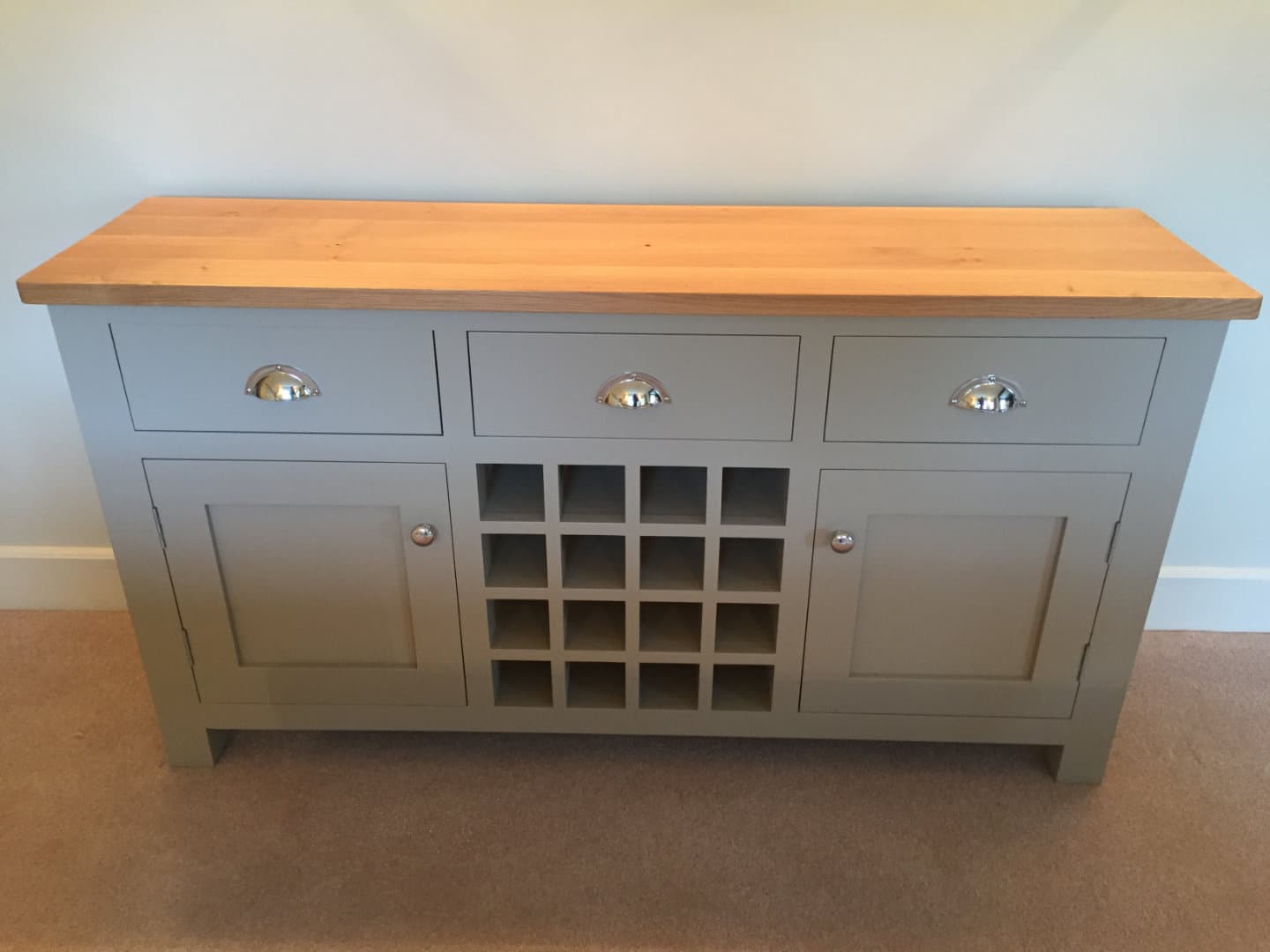 A beautiful wooden sideboard with an oak top finish