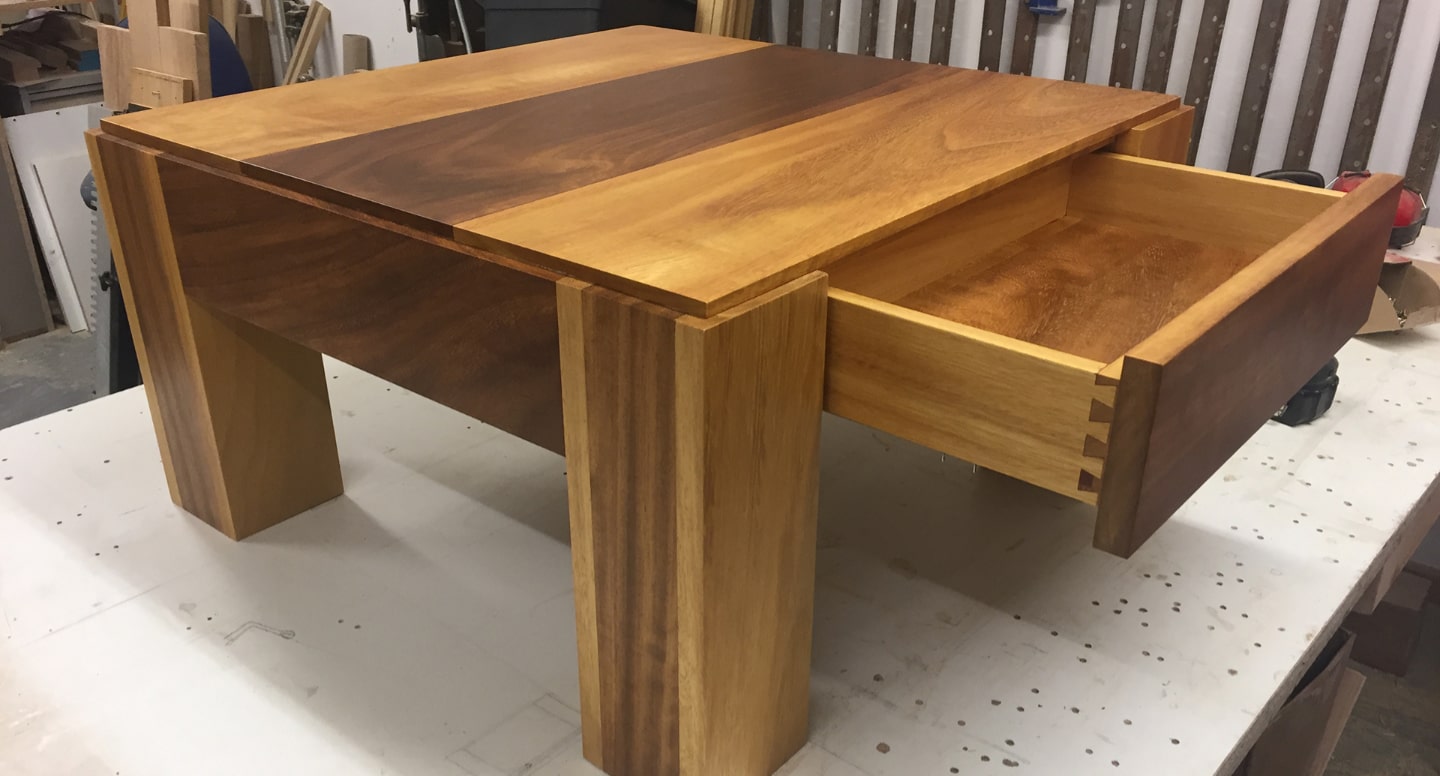 A wooden coffee table with storage underneath