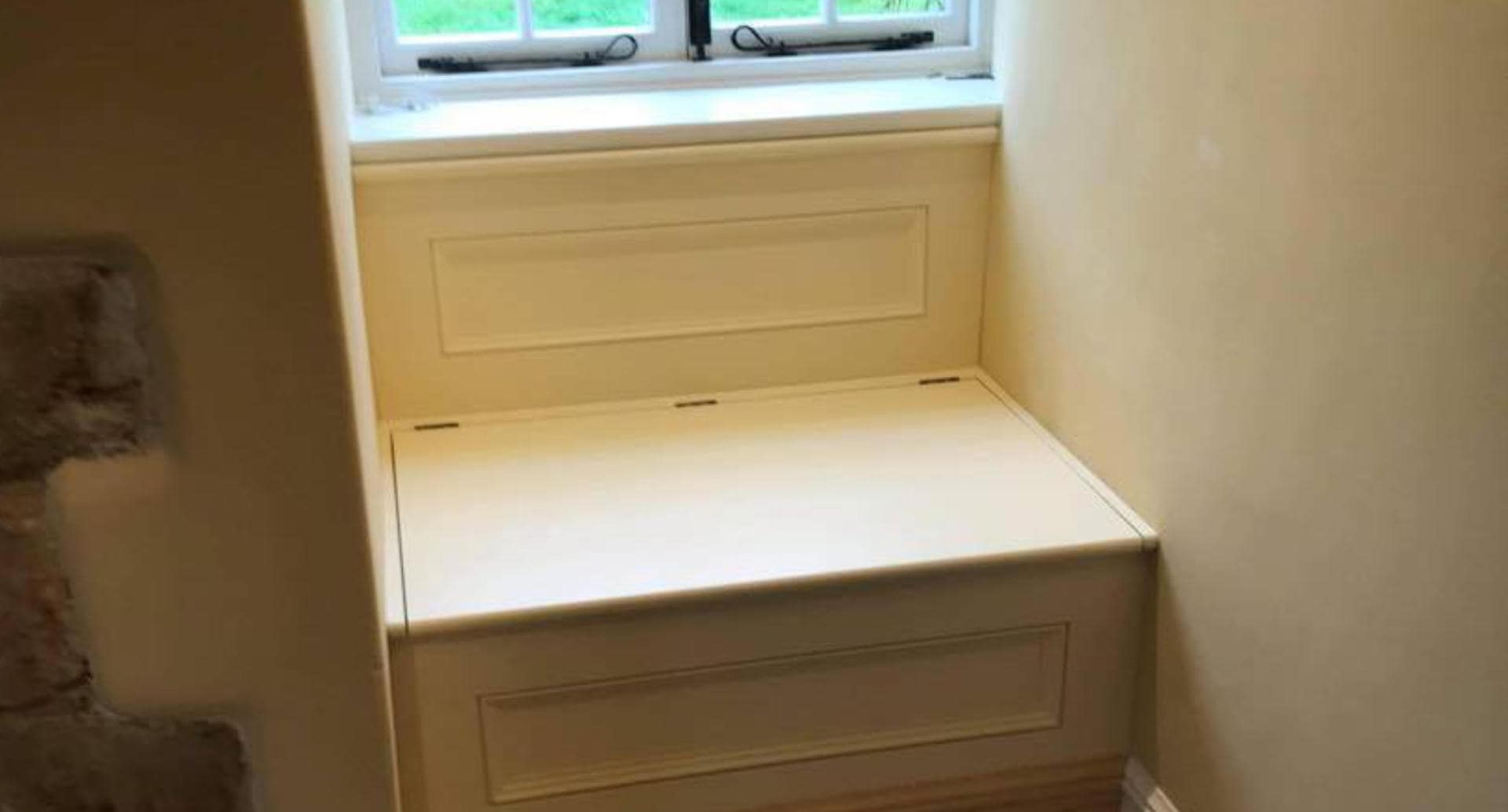 A bespoke window seat with integrated storage solution