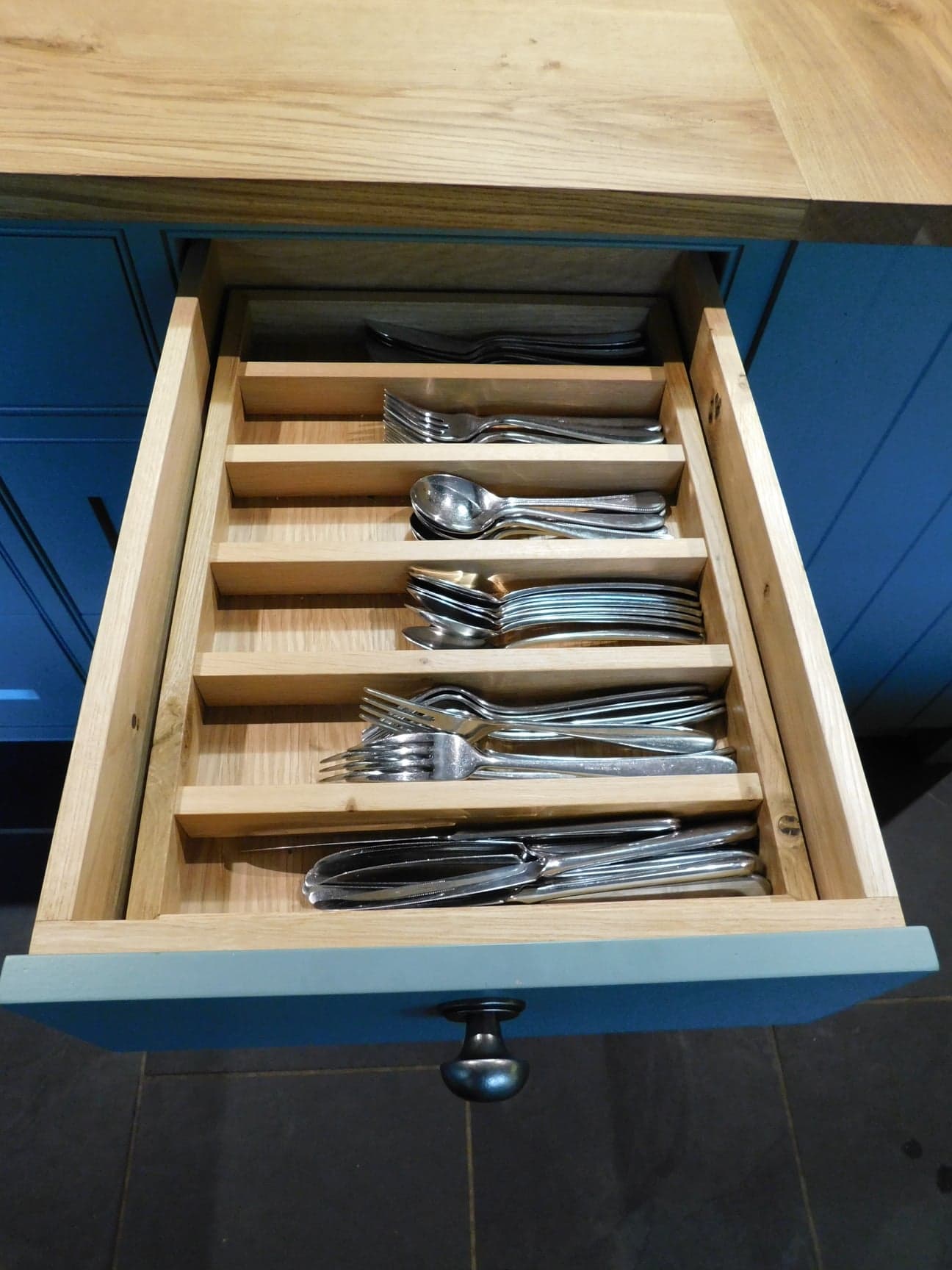 An open drawer revealing an array of utensils.