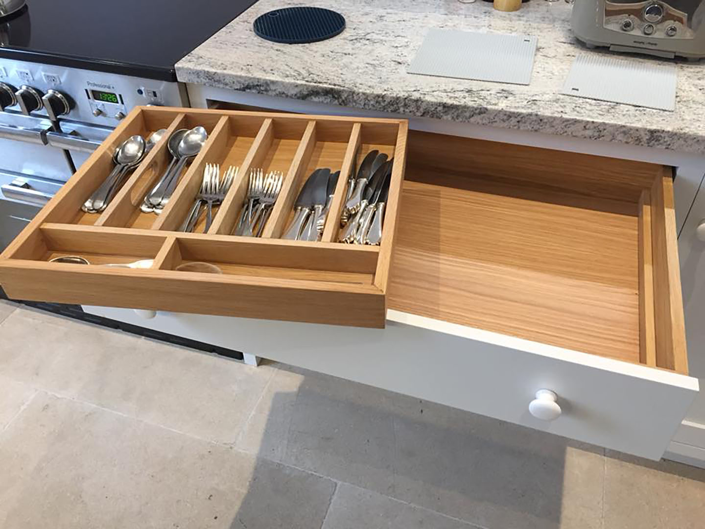 The cutlery draw showing the utensils inside.
